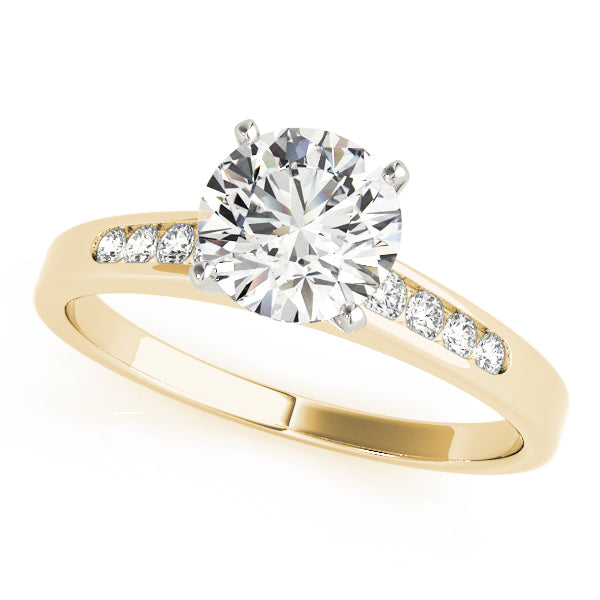 Elegant angled view of round brilliant cut lab grown diamond engagement ring with tapered channel set band in yellow gold