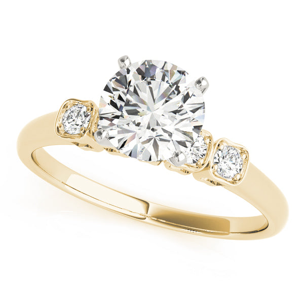 Yellow gold round lab diamond three-stone engagement ring.
