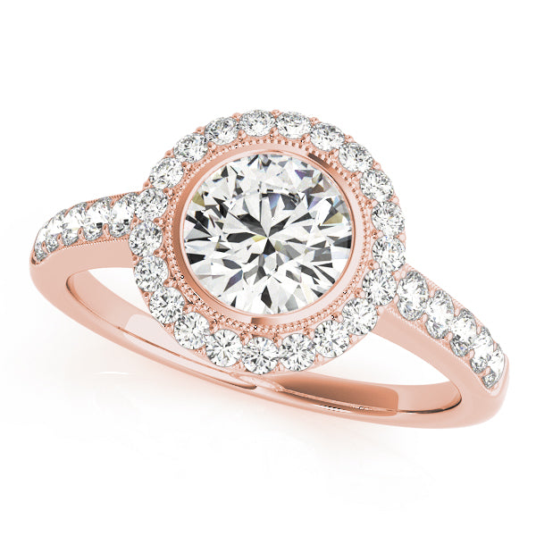 Three-quarter perspective shot of a rose gold bezel-set round diamond halo ring
