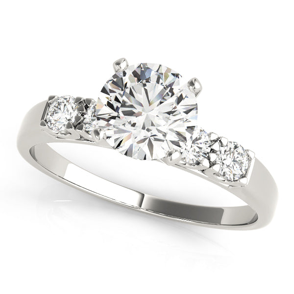 Top view of a white gold round diamond ring with scalloped prong shank