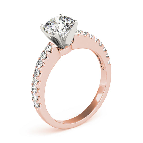 Angled profile of rose gold round diamond ring highlighting pave setting.