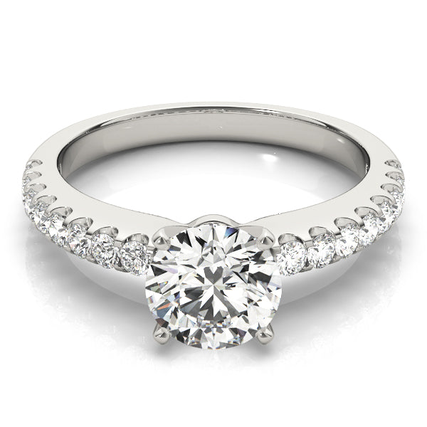 Classic round diamond engagement ring with pave band in 14K white gold.