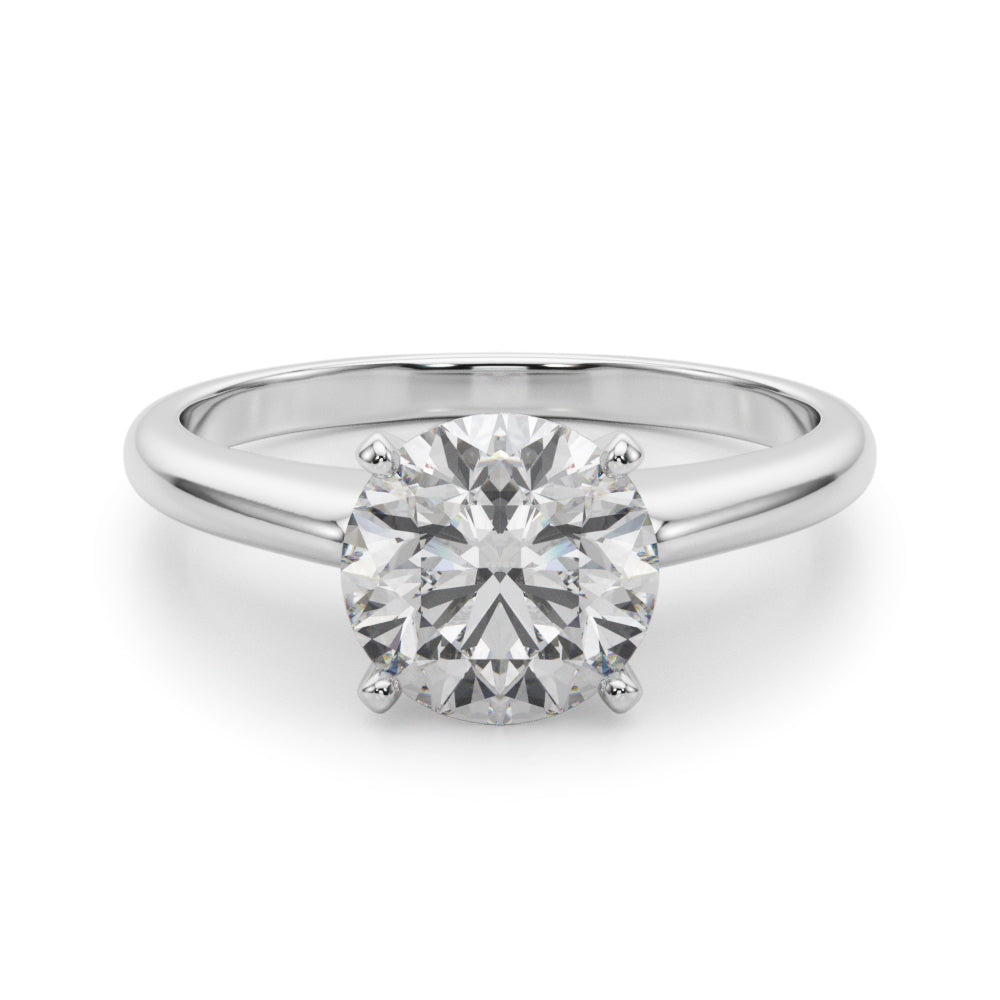 High-set 4-prong profile view of a round lab grown diamond solitaire engagement ring in white gold.