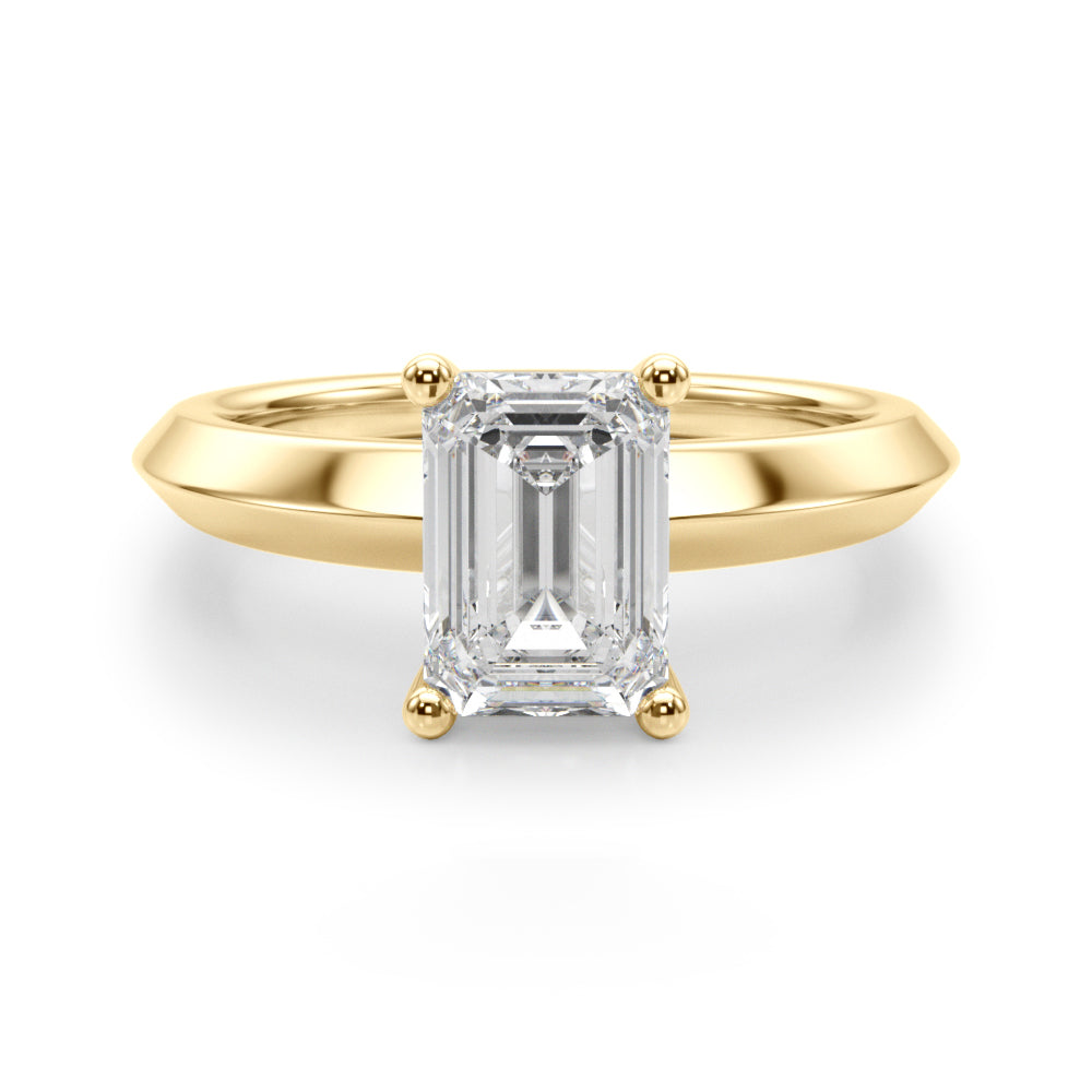 Perfect front-facing view of yellow gold knife edge ring holding a rectangular emerald cut diamond