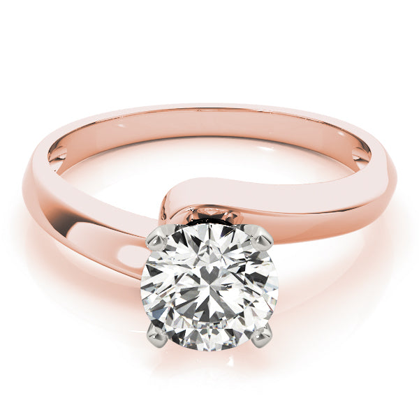 round diamond solitaire ring with a twisting shank in 14K rose gold.
