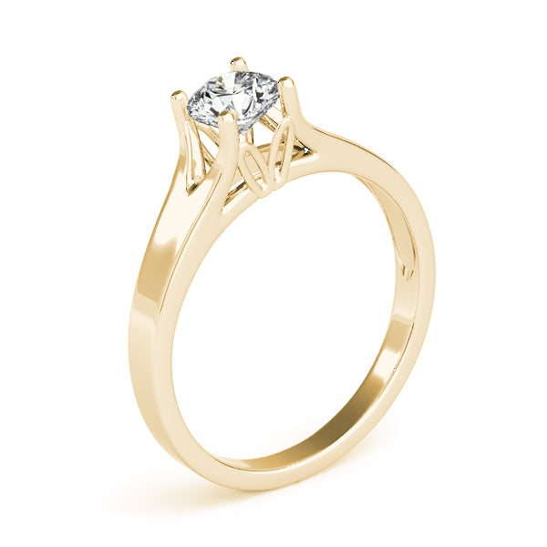 Detailed side view of the yellow gold infinity prong setting for a round diamond.