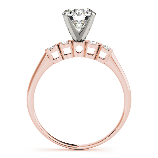 Side view of rose gold three-stone engagement ring.