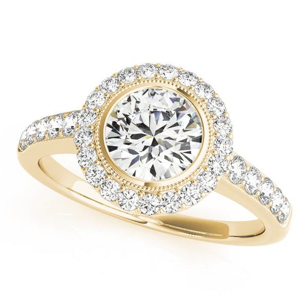 Angled top view of a yellow gold vintage engagement ring featuring a round center diamond in a milgrain bezel setting with a sparkling halo.