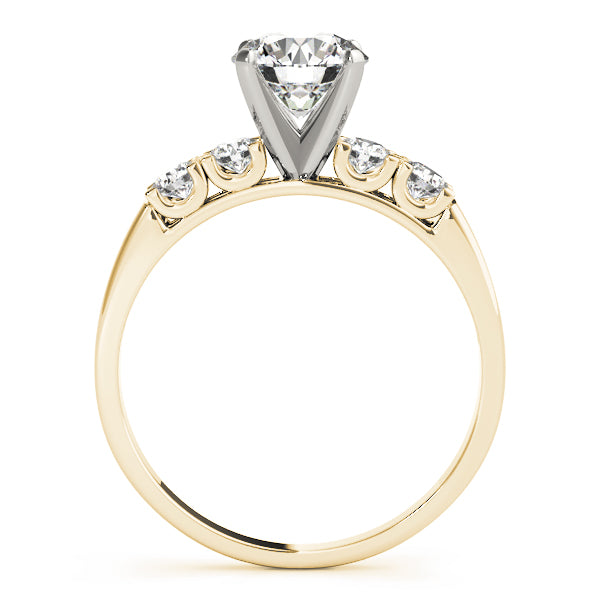 Side profile of a yellow gold engagement ring showing U-shape diamond setting