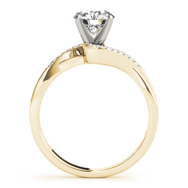 side profile of a yellow gold bypass ring showing the classic 4-prong basket setting