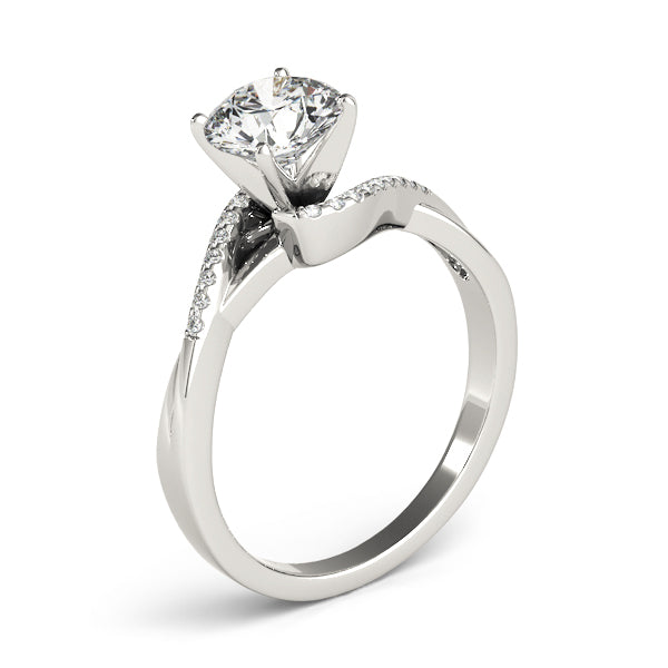 Tilted vertical product shot of a white gold bypass solitaire ring