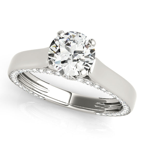 Angled studio shot of a white gold round cut lab diamond cathedral setting engagement ring.