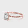 360-degree rotation of rose gold emerald cut diamond ring with twisted band